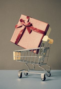 huge red gift box in shopping cart - online shopping