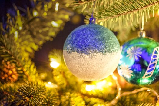 christmas decorations on snowy fir tree