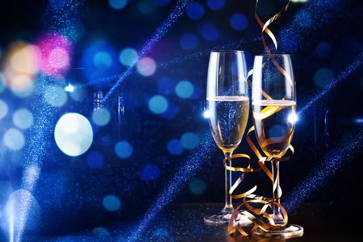 two glasses of champagne in the spotlight - new year celebration