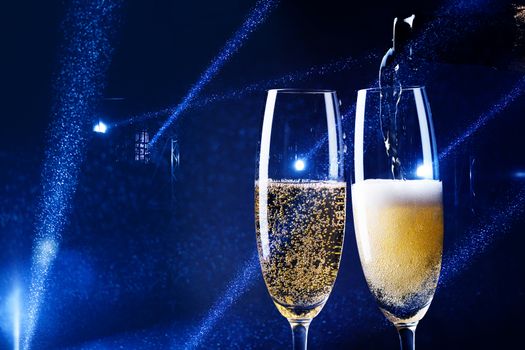 two glasses of champagne in the spotlight - new year celebration