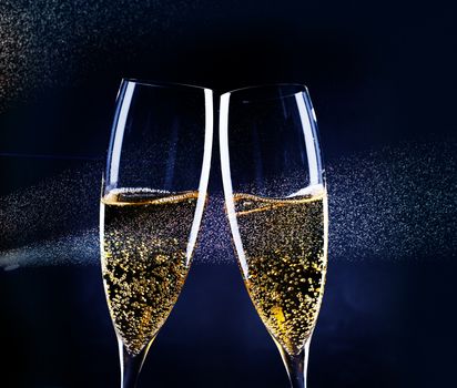 two glasses of champagne in the spotlight - new year celebration