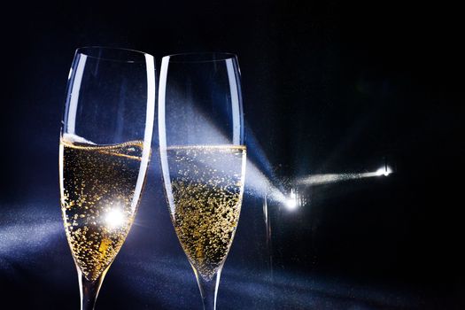 two glasses of champagne in the spotlight - new year celebration