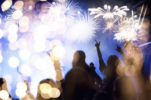 crowd watching fireworks - New Year celebrations- abstract holiday background