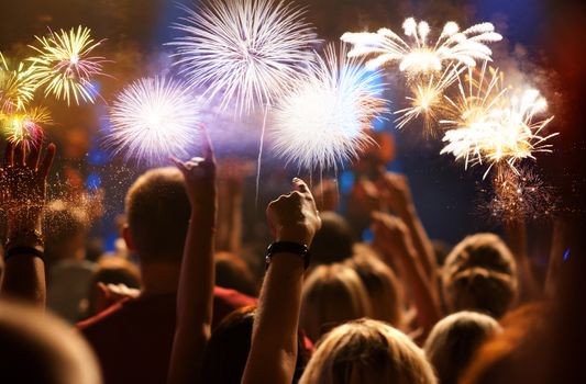 crowd watching fireworks - New Year celebrations- abstract holiday background