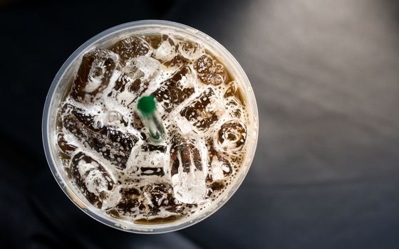 top view of Ice coffee in a plasstic glass with straw