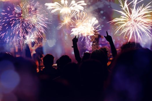 crowd watching fireworks - New Year celebrations- abstract holiday background