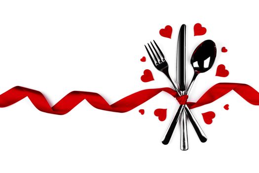 Cutlery set tied with silk ribbon and hearts isolated on white background Valentine day dinner concept