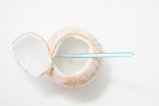 top view of coconut water with drinking straw isolated on white background