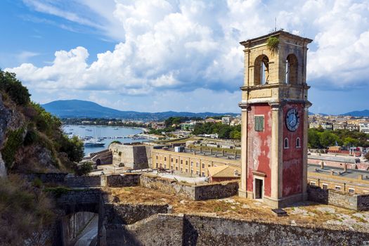 Abandoned clock tower in old fortress in Corfu with panoramic view of Corfu town at Greece.