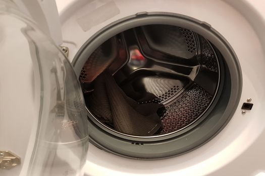 Opened door of a washing machine to prepare the wash.