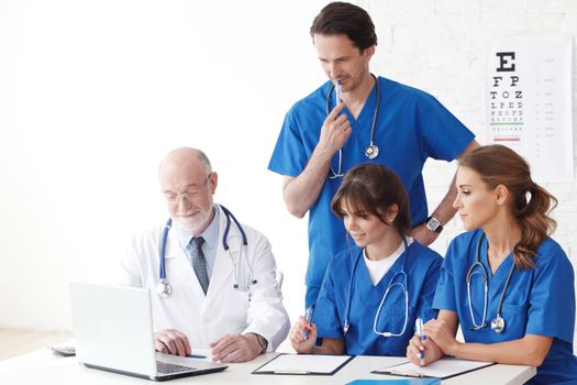 Medical doctors team using computer isolated on white