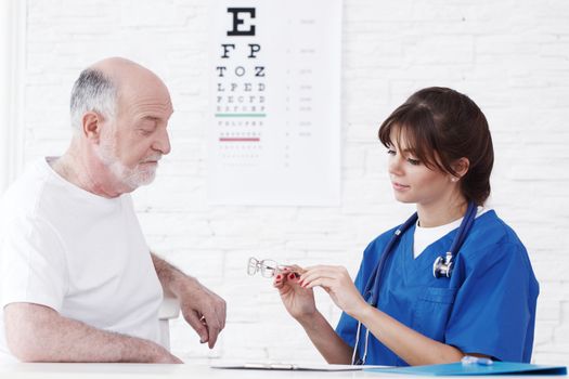 Doctor making vision test for new glasses