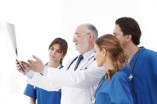 Medical team checking on X-ray results isolated on white