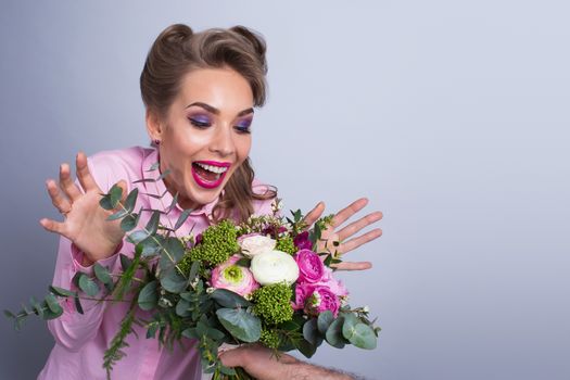 Woman surprised with bunch of flowers, funny emotional expression