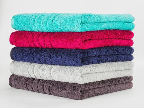 Pile of Multicolored towels on a white background