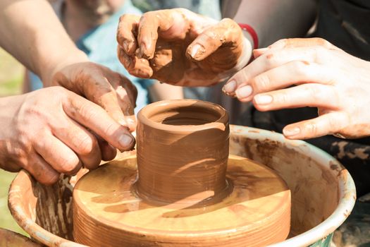 Master class on modeling of clay on a potter's wheel in the pottery workshop