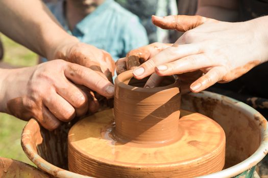 Master class on modeling of clay on a potter's wheel in the pottery workshop