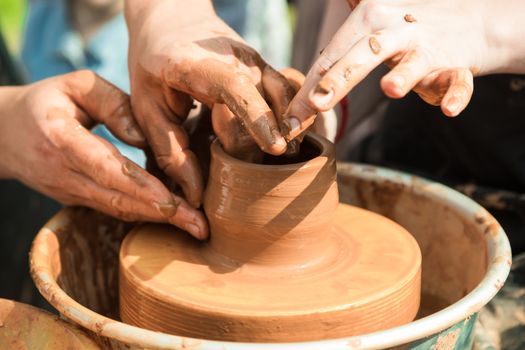 Master class on modeling of clay on a potter's wheel in the pottery workshop
