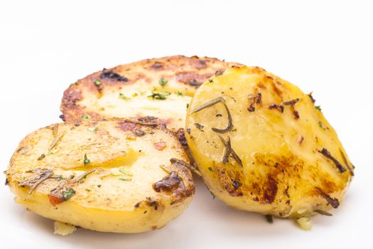 Coocked yellow color poatao with spices and herbs isolated on white
