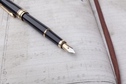 Old ink pen and notebook closeup