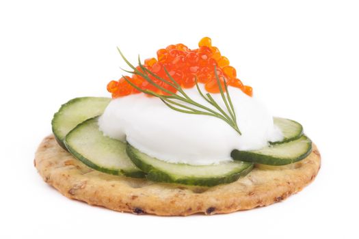 Red caviar on white chees and green cucumber apetiser on white background