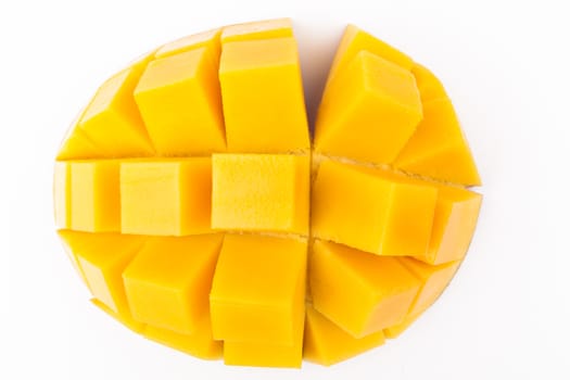 Mango slice cut to cubes close-up isolated on white background