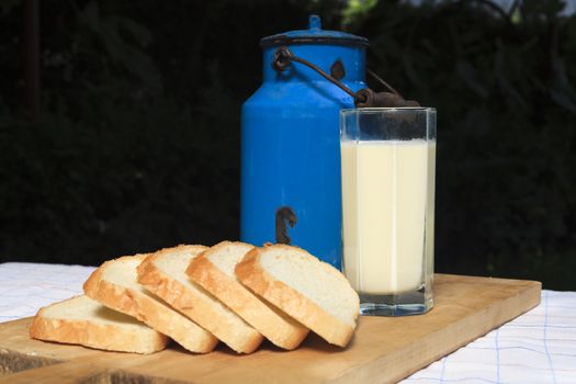 Milk and bread on a wood plate