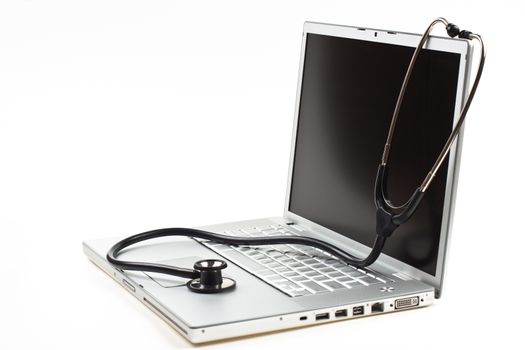 silver laptop diagnosis with black stethoscope  isolated on white background