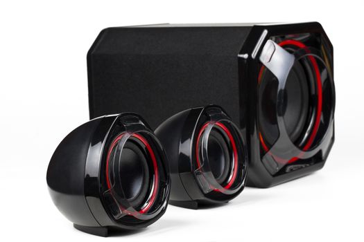 3D sound system build from 3 way speakers and a woofer all black with red circle isolated on white background