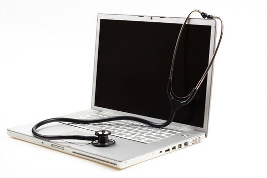 silver laptop diagnosis with black stethoscope  isolated on white background