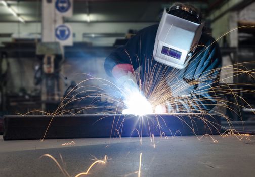 Welding with a lot of sparks in a metal industry factory 