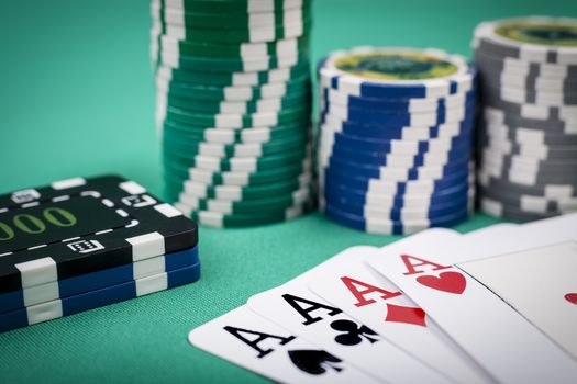 Cards and casino chips on green background