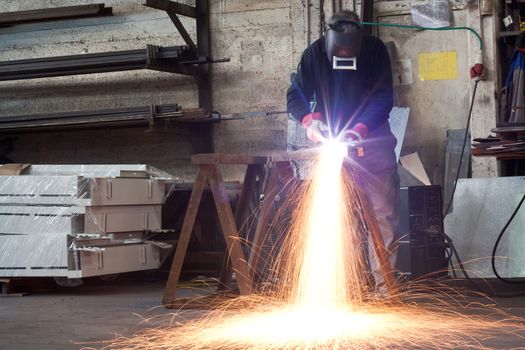 manual plasma cuting in a steel factory lot's of sparks all over