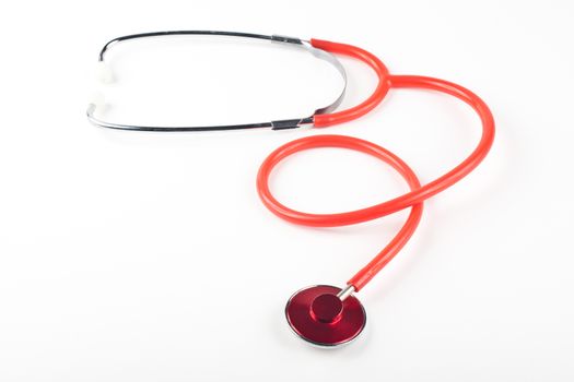 red stethoscope close-up isolated on white background