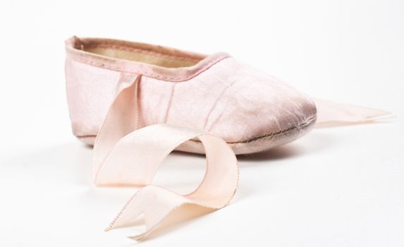 single pink balerina shoe close-up isolaed on white
