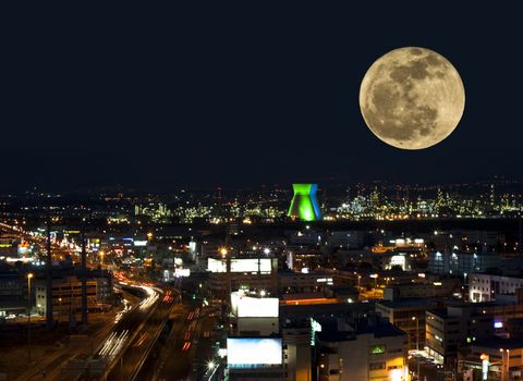 haifa bay industrial zone with a highway and giant moon above