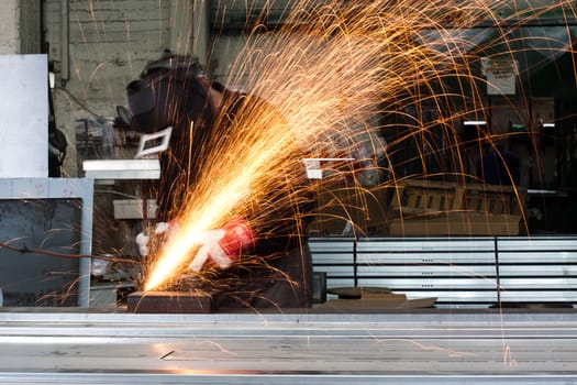 sparks flying during grinding in a metal workshop