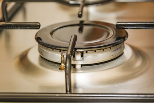 Close-up view of a stove burner in a metal kitchen. interior shot