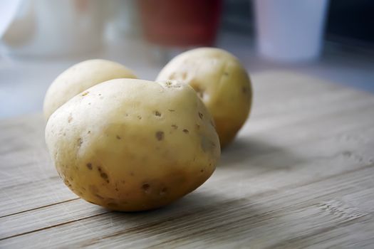 Still life of raw potatoes on a wooden table. Food and health concept. Carbohydrate