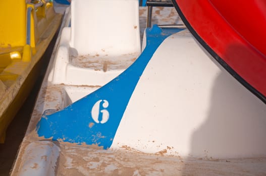 White number six in the side of the pleasure boat, seashore, summer