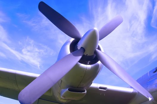 Aircraft propeller on the wing, blue sky background