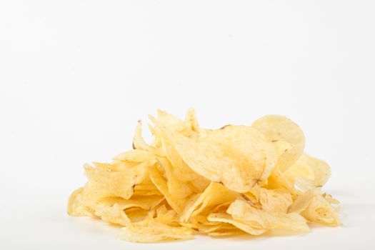 yelow potato chips pile isolated on white background