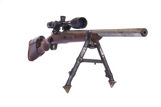 Old Sniper Rifle with scope atached on a tripod isolated on white background