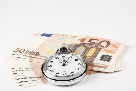 stopwatch closeup pointing at 5 seconds on a pile of 50 euro bills isolated on white backgrpund