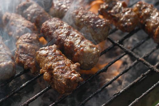 barbeque meat on the grill with white smoke