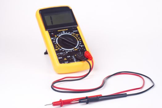 yellow multimeter with black and red probs focus on the probs isolated on white