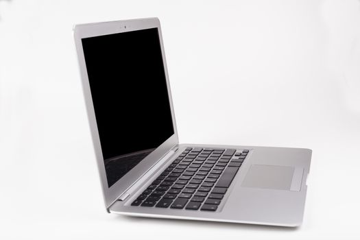 Thin silver laptop side view with black screen and keyboard reflection in the screen isolated on white background