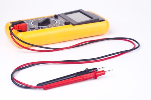 yellow multimeter with black and red probs focus on the probs isolated on white