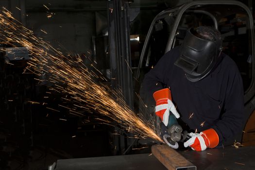 orange sparks during metal grinding in heavy industry plant
