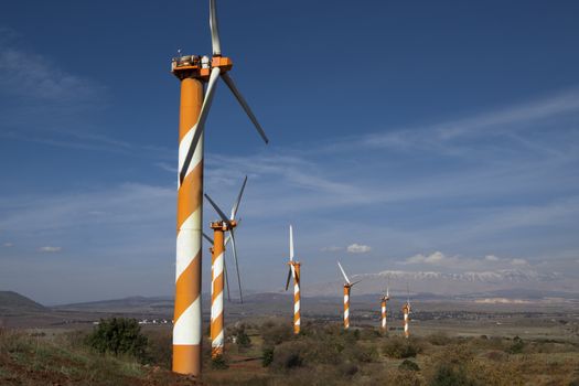 six wind mill on a mountain top producing polution free electricity